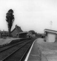 042 Shillingstone Station July 1962
Notice 1) the ‘up’ platform garden layout and maturity of the Cypress fir tree.
2) the bird bath in the garden (still existent!).
3) the passenger warning notice on left.
4) the old style lamp support posts on 